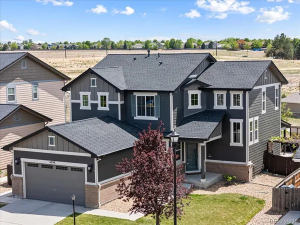 a aerial view of a house next to a yard