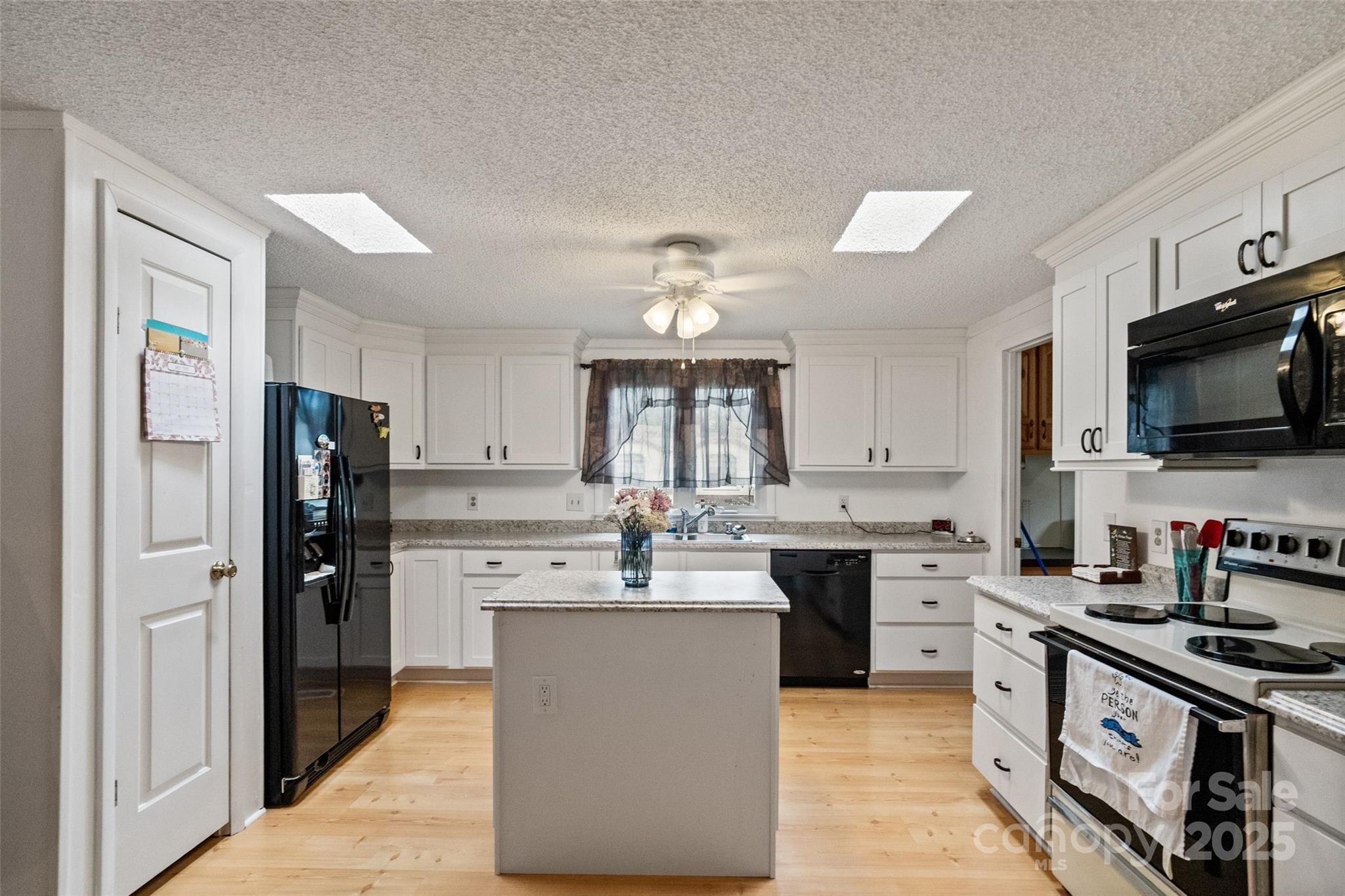 5909 Lake Valley Road Clover, SC 29710 - Photo 15 of 44 a large kitchen with stainless steel appliances granite countertop a stove refrigerator and cabinets