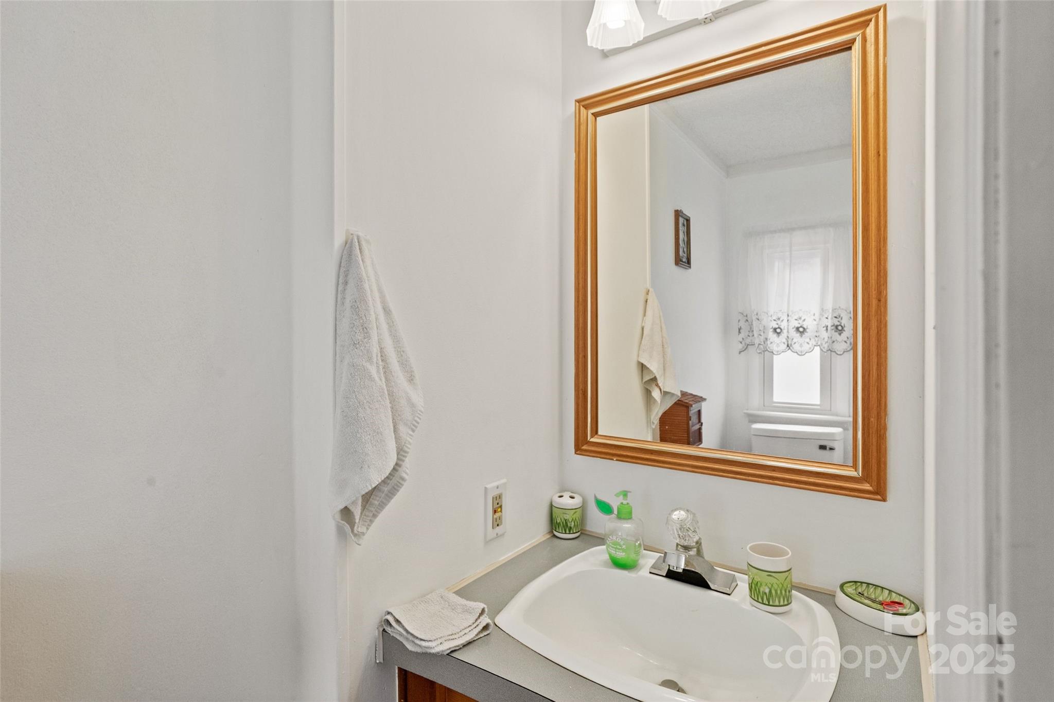 5909 Lake Valley Road Clover, SC 29710 - Photo 20 of 44 a bathroom with a sink a mirror and a window