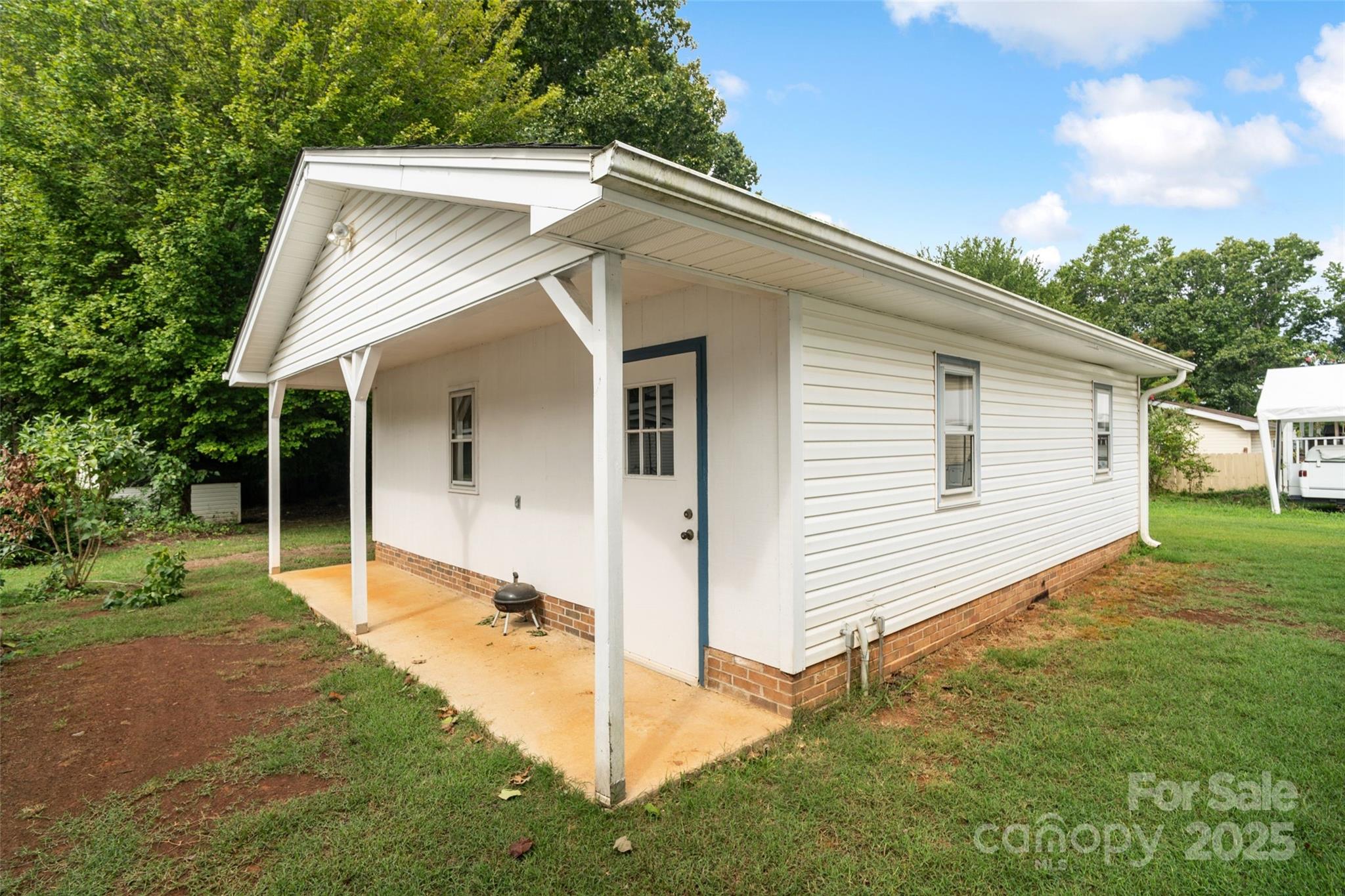 5909 Lake Valley Road Clover, SC 29710 - Photo 5 of 44 a view of a white house next to a yard with big trees