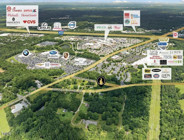 an aerial view of residential houses with outdoor space and river