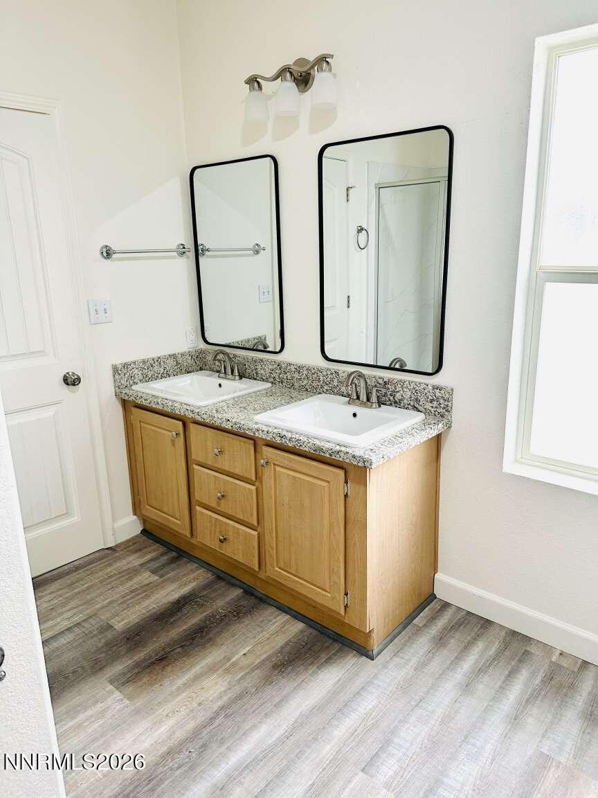 6255 Sierra Way Fallon, NV 89406 - Photo 11 of 25 a bathroom with a granite countertop double vanity sink and mirror