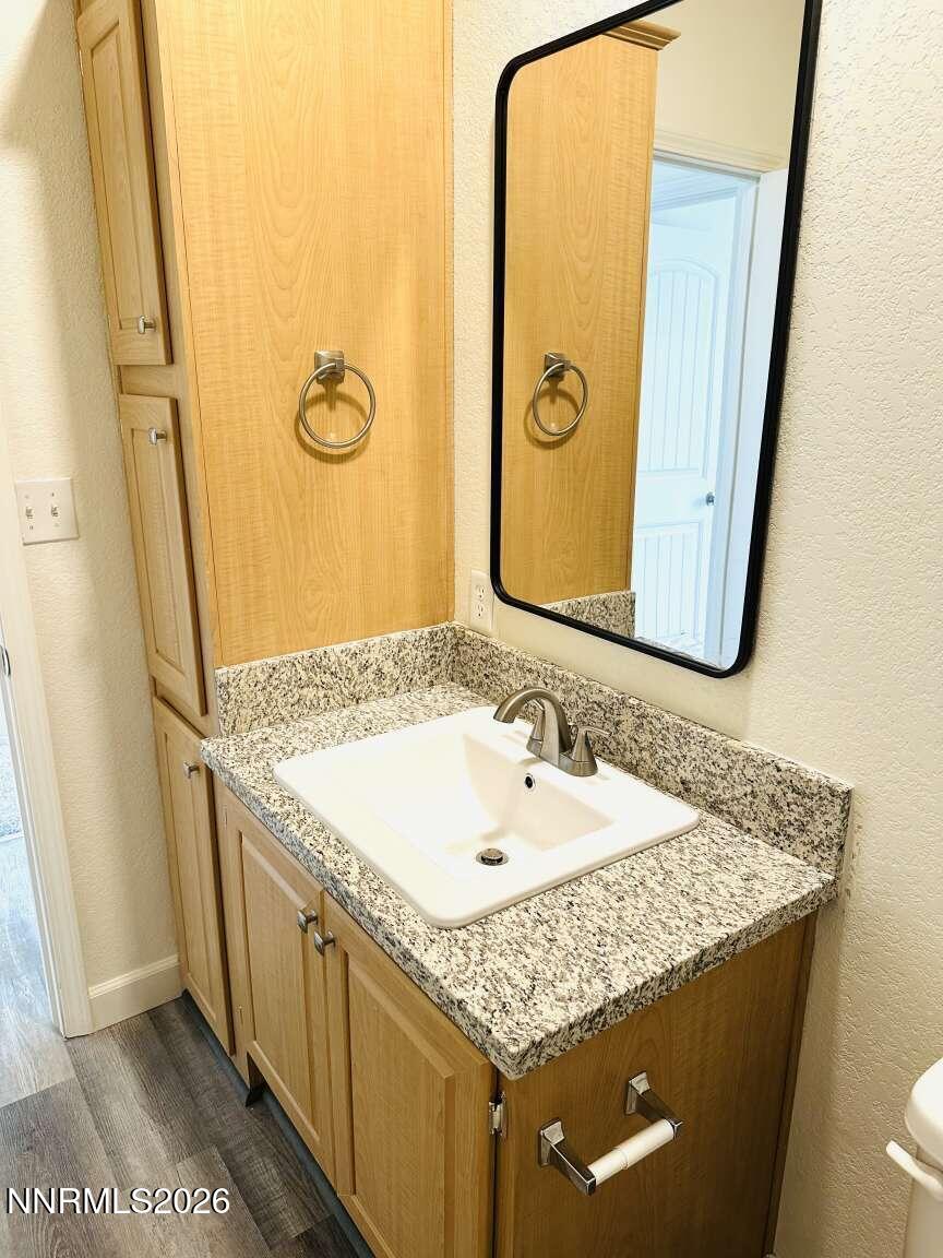 6255 Sierra Way Fallon, NV 89406 - Photo 18 of 25 a bathroom with a granite countertop sink and a mirror