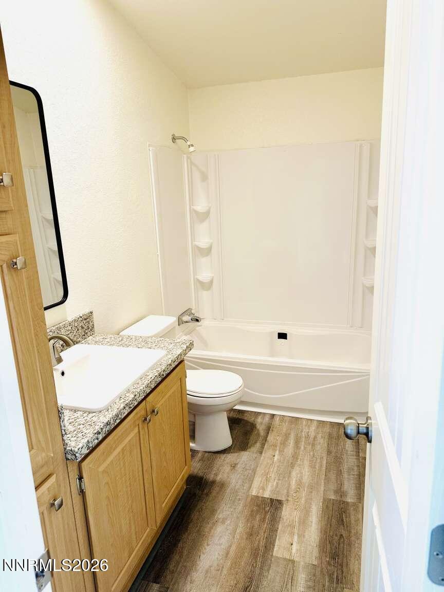 6255 Sierra Way Fallon, NV 89406 - Photo 19 of 25 a bathroom with a granite countertop sink toilet and shower