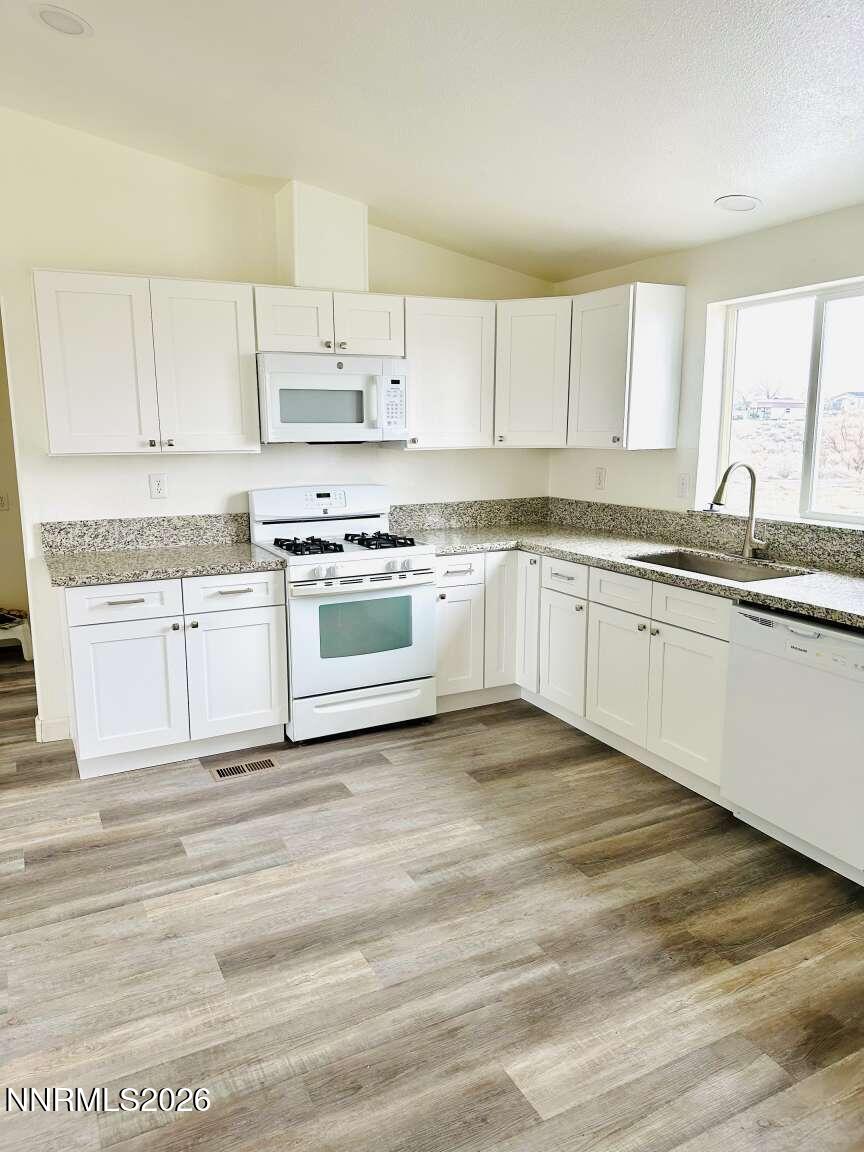 6255 Sierra Way Fallon, NV 89406 - Photo 4 of 25 a large kitchen with granite countertop a sink and cabinets