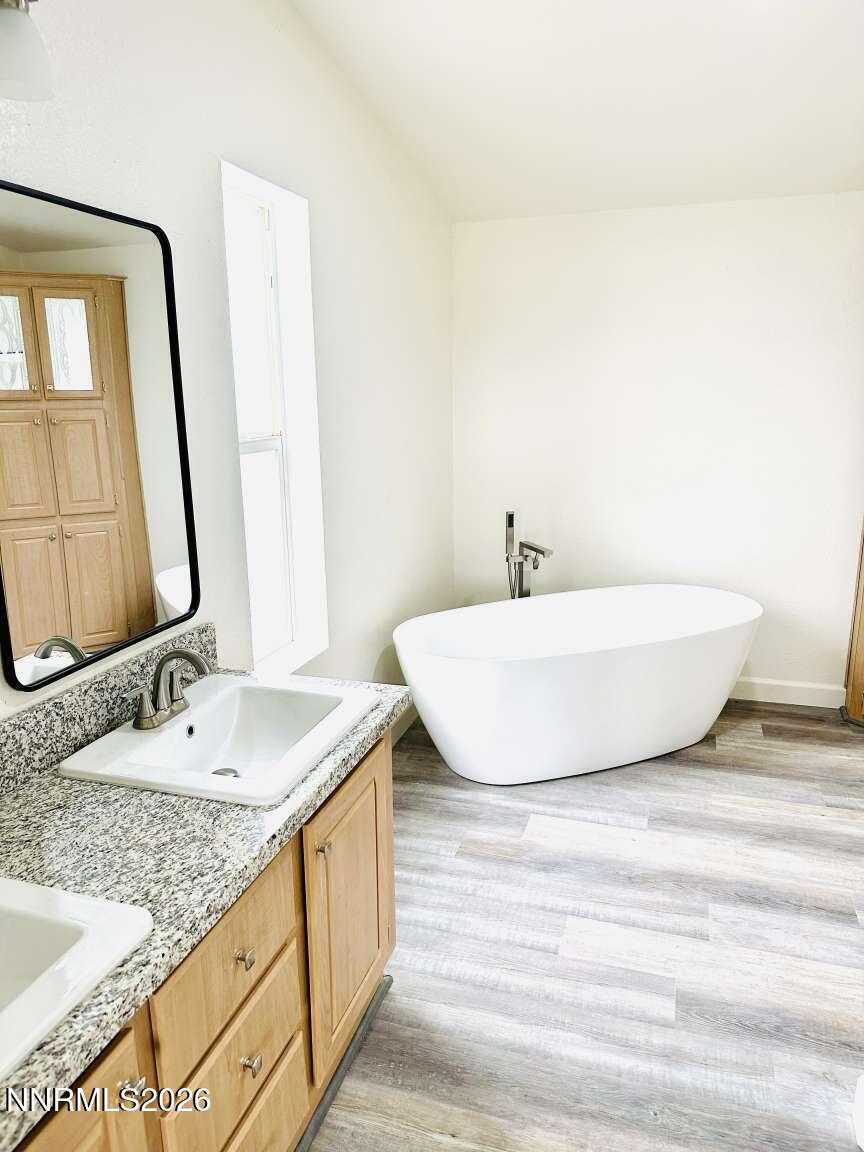 6255 Sierra Way Fallon, NV 89406 - Photo 9 of 25 a bathroom with a granite countertop sink and a mirror
