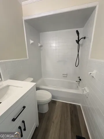 a bathroom with a sink a toilet and a bathtub