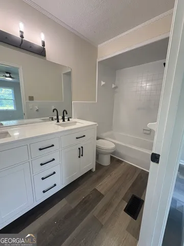 a bathroom with a double vanity sink toilet and shower