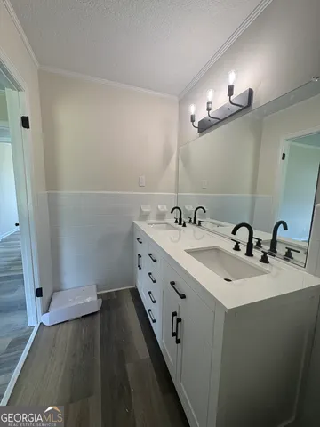 a bathroom with a double vanity sink and a mirror