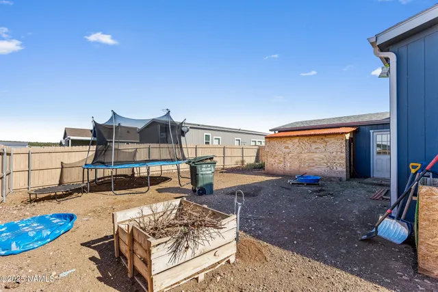 a living room with furniture a rug and gym equipment