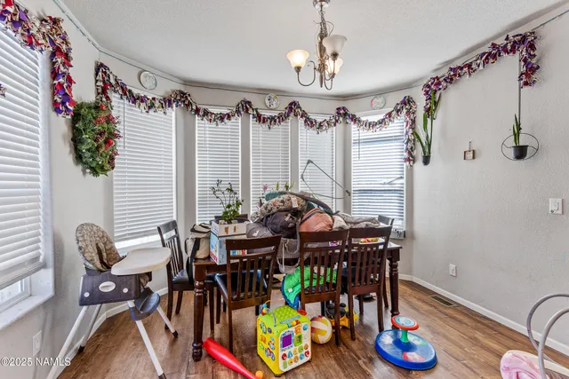 a view of a dining room with furniture one side kitchen view
