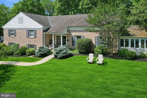 a view of a house with a yard porch and sitting area