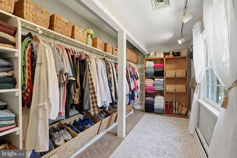 a bedroom with furniture and wooden floor