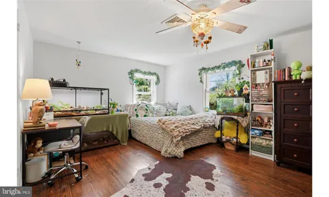 a spacious bedroom with a bed and a large cabinets