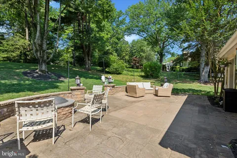 an aerial view of a house with a yard and outdoor seating