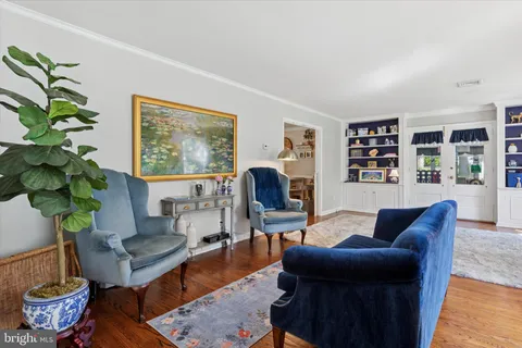 a living room with furniture potted plant and a window