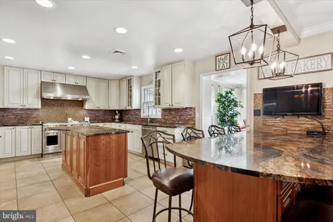 a kitchen with kitchen island granite countertop a sink and counter space