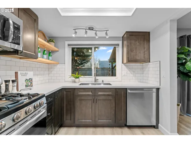 a kitchen with a sink stove and microwave