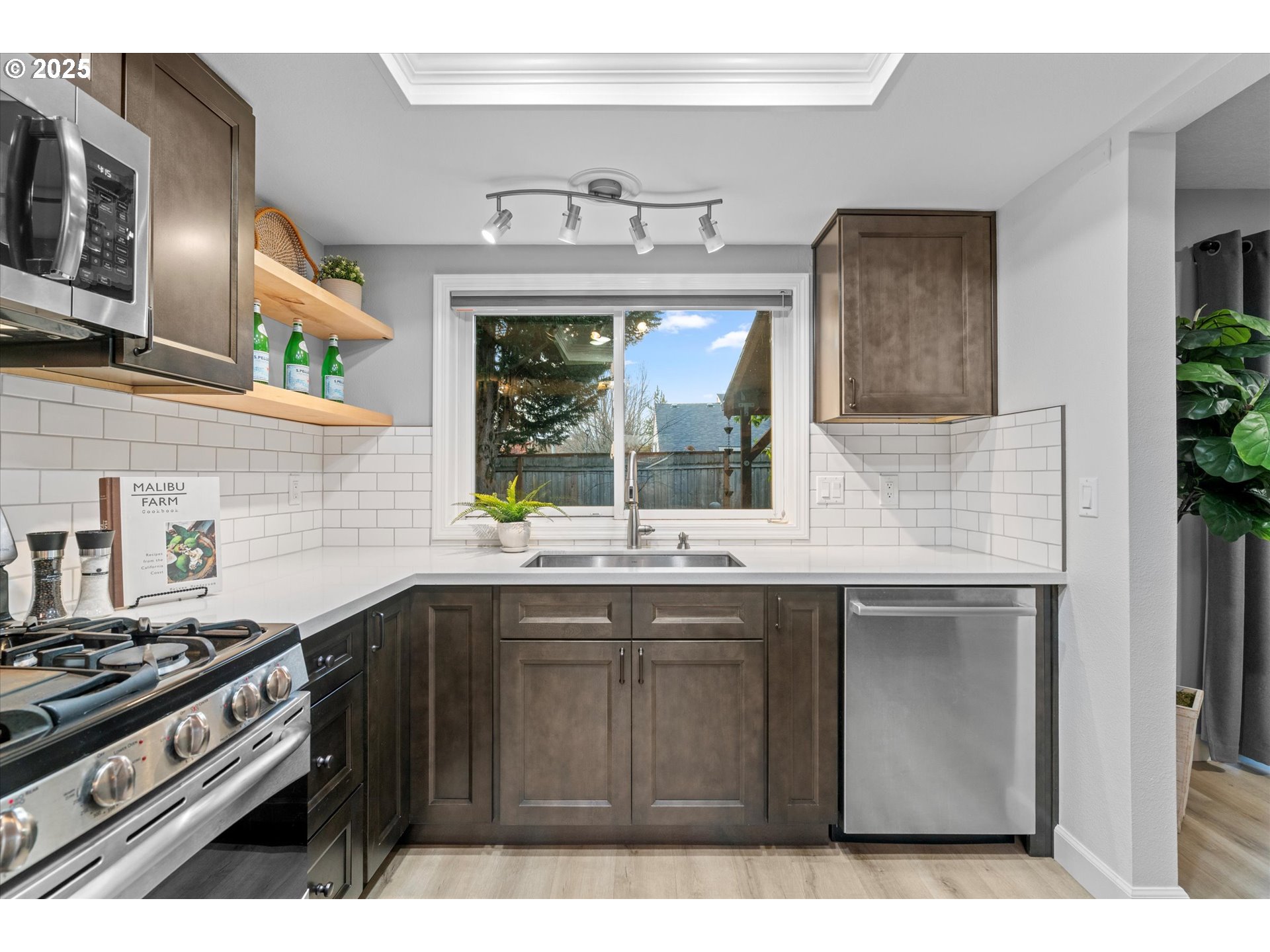 15975 Southwest 87th Avenue Portland, OR 97224 - Photo 11 of 35 a kitchen with a sink stove and microwave