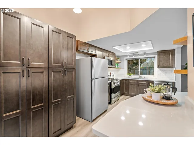 a kitchen with refrigerator and window