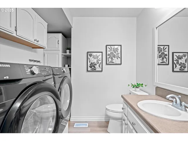 a en suite bathroom with a toilet a sink and mirror