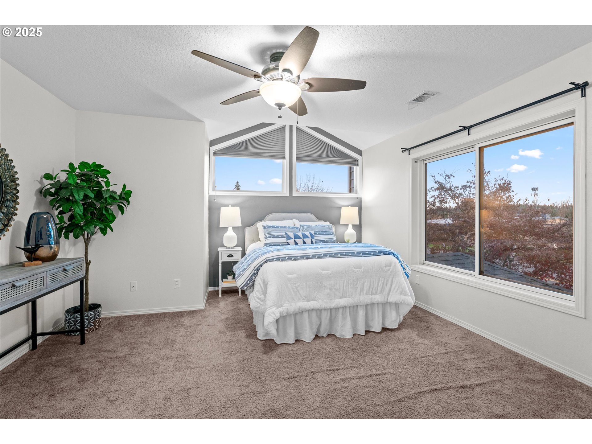 15975 Southwest 87th Avenue Portland, OR 97224 - Photo 15 of 35 a bedroom with a bed and a chandelier