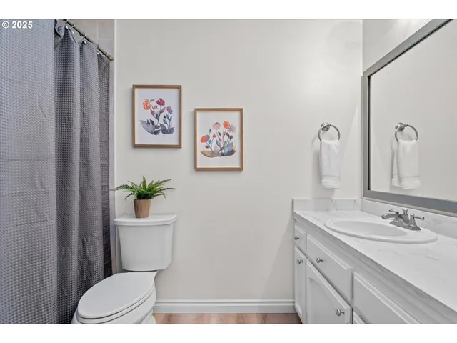 a bathroom with a sink a toilet and mirror