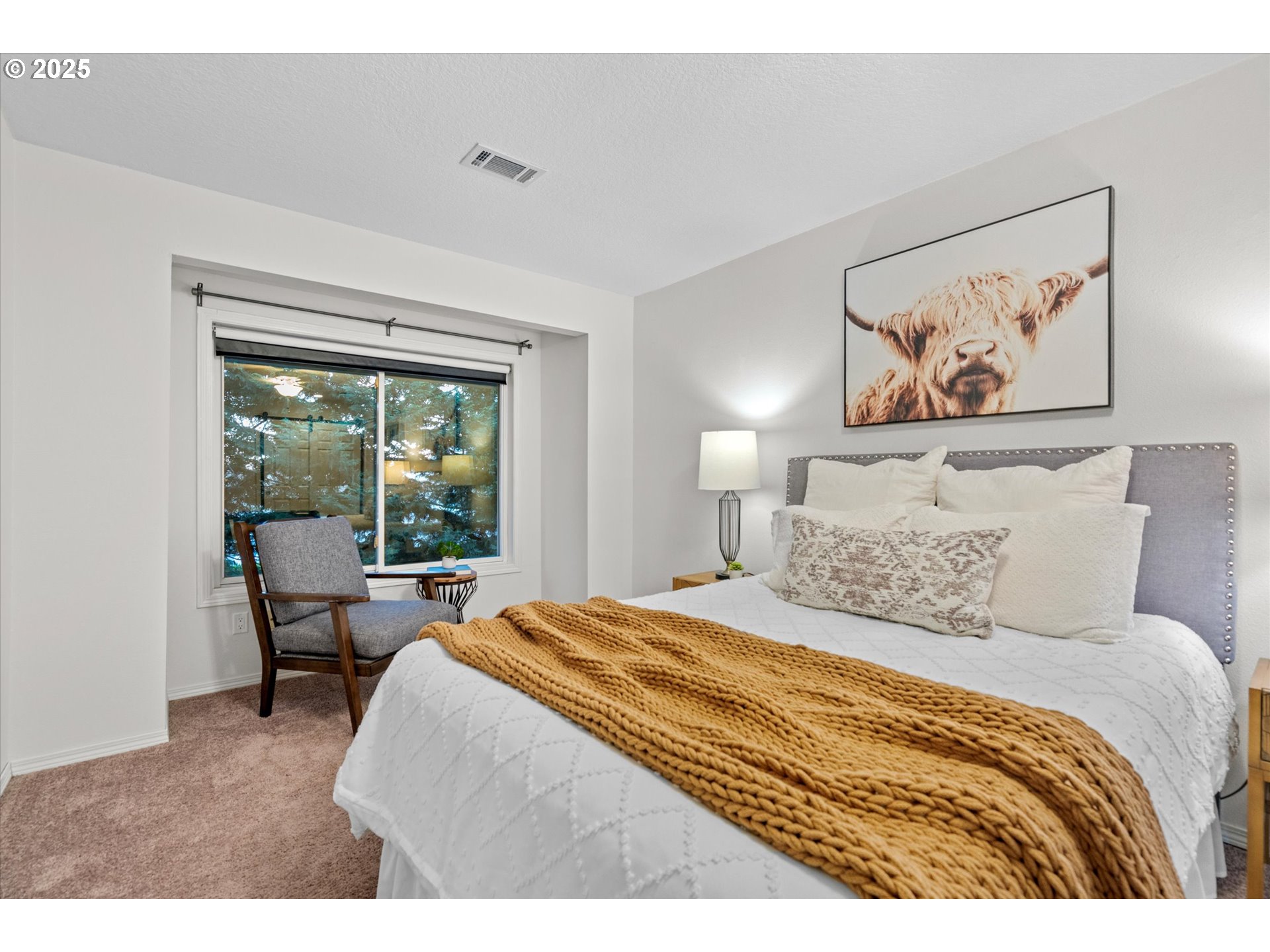 15975 Southwest 87th Avenue Portland, OR 97224 - Photo 23 of 35 a bedroom with a large bed and a painting on the wall