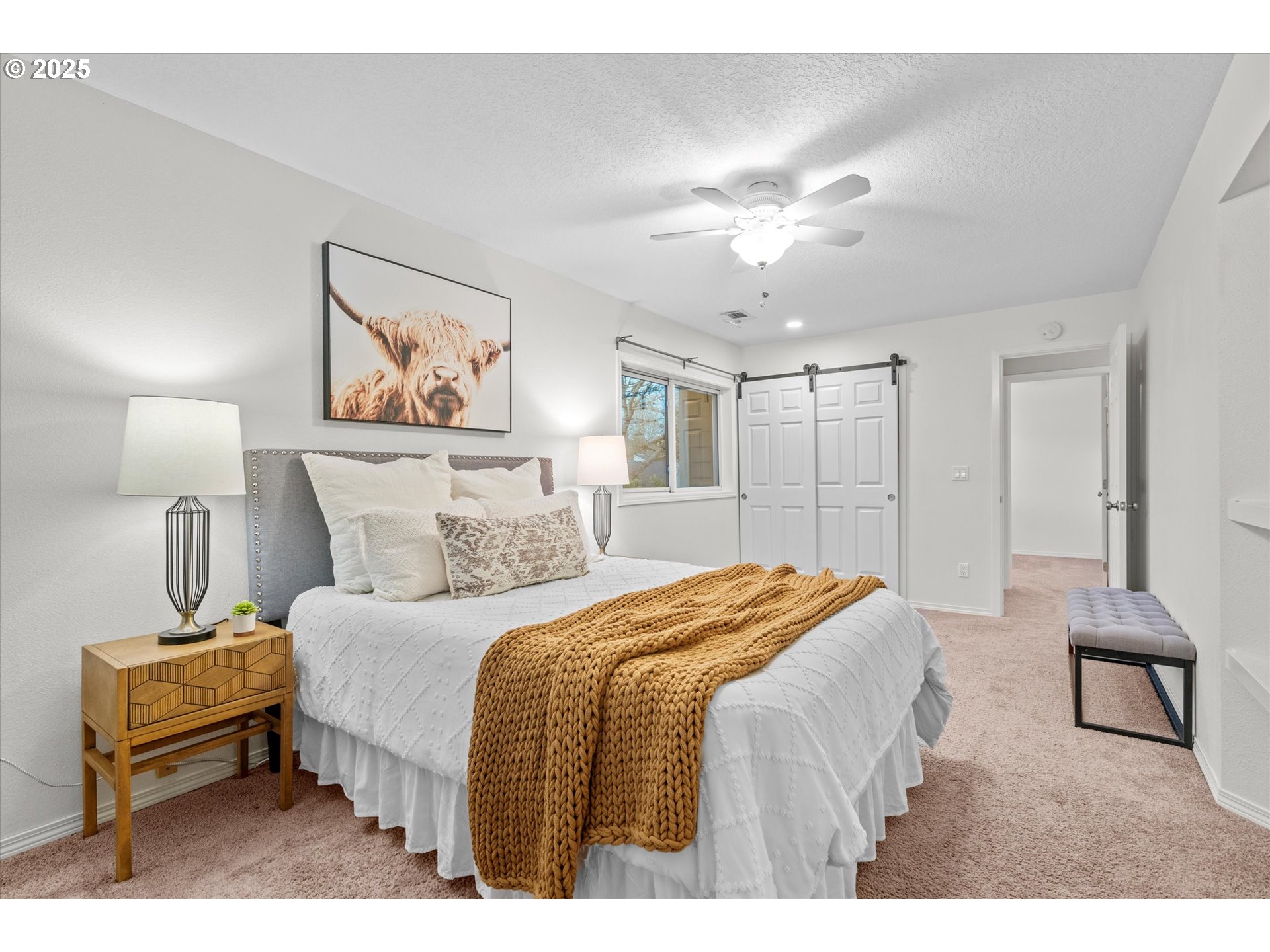 15975 Southwest 87th Avenue Portland, OR 97224 - Photo 24 of 35 a bedroom with a bed and a chandelier