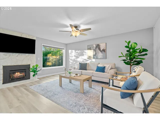 a living room with furniture a fireplace and a flat screen tv