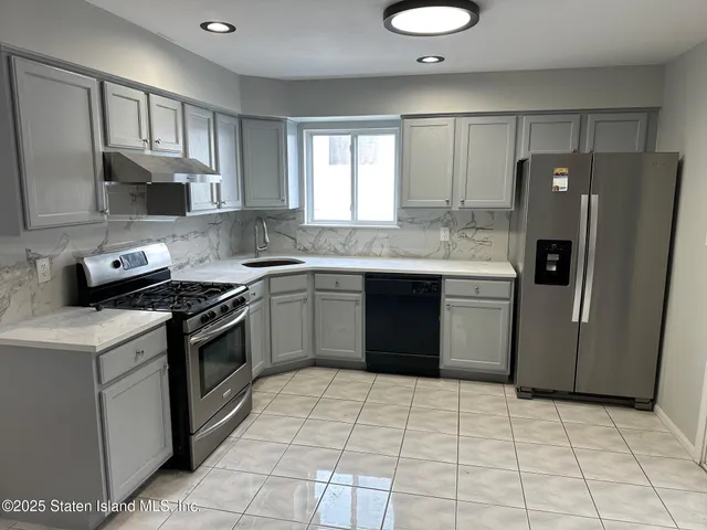 a kitchen with a stove sink and refrigerator