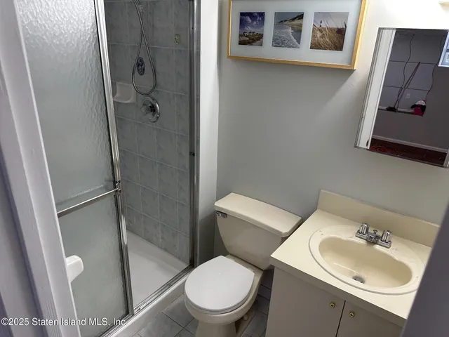 a white toilet sitting next to a bathroom sink