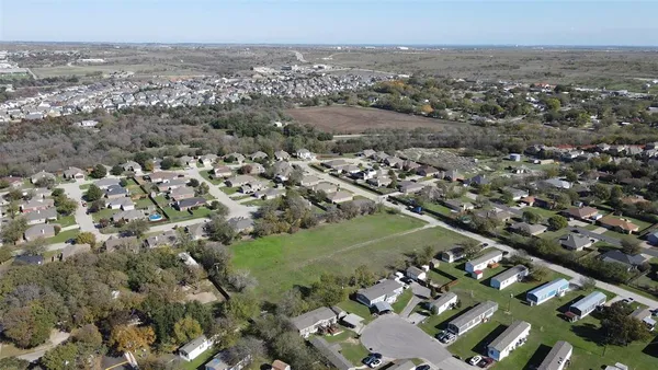 an aerial view of residential house with green space