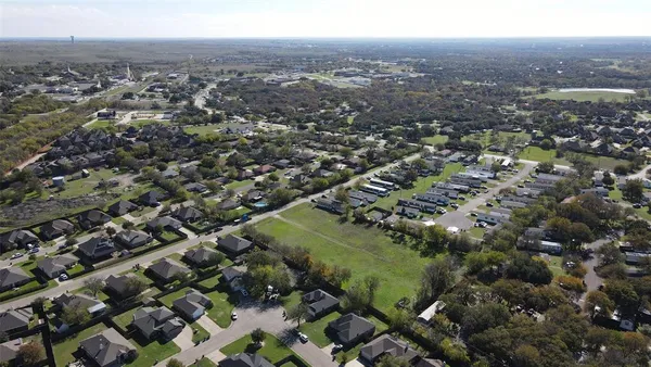 an aerial view of residential house and car parked
