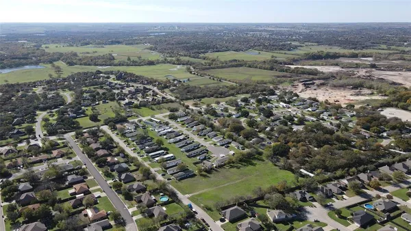 an aerial view of a residential houses with outdoor space