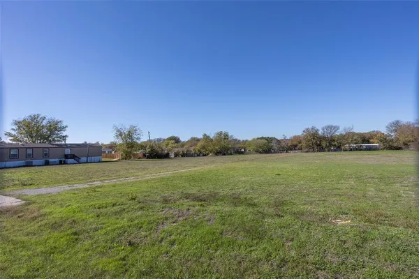 a view of a field with an ocean