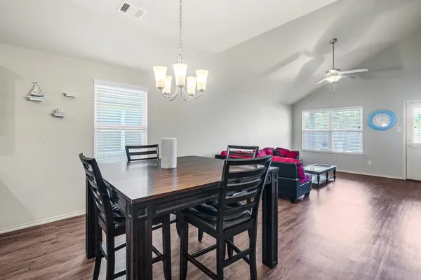 a view of a dining room with furniture wooden floor and chandelier