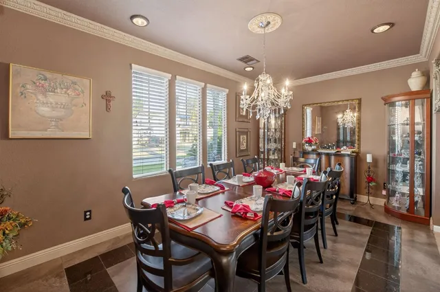 a view of a dining room with furniture and chandelier