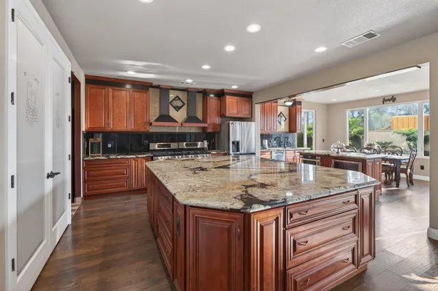 a kitchen with stainless steel appliances granite countertop a sink and cabinets