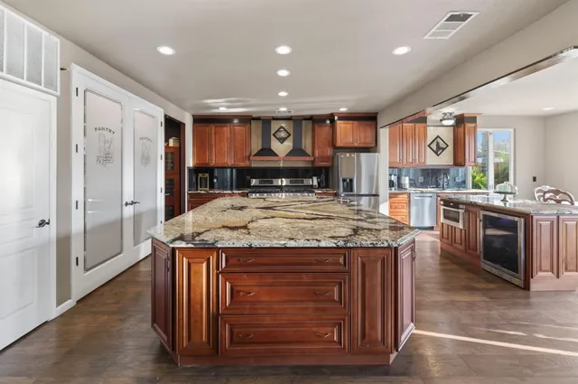 a kitchen with a stove a sink and a refrigerator