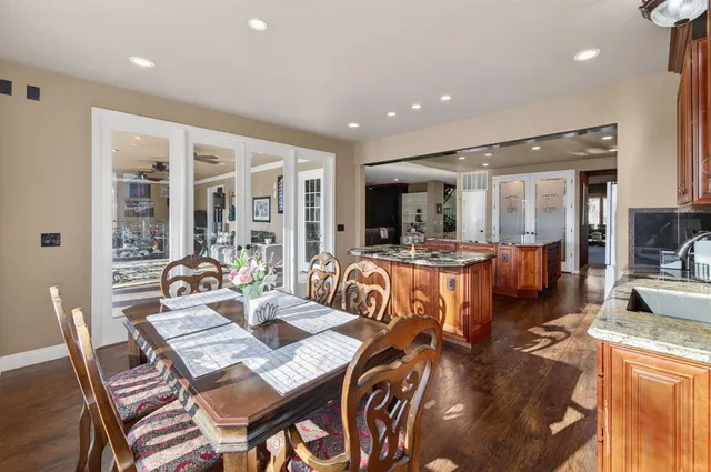 a kitchen with stainless steel appliances granite countertop a sink and a wooden cabinets