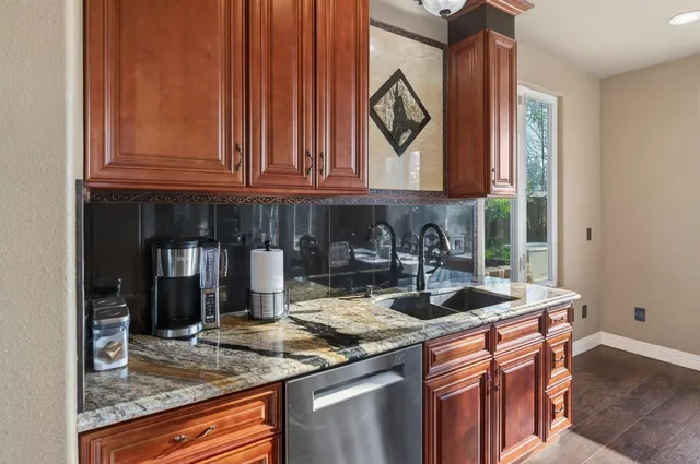 a kitchen with stainless steel appliances granite countertop a stove and a sink
