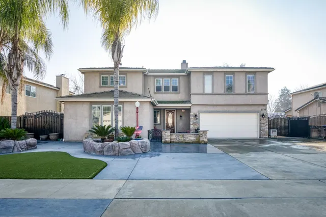 a front view of a house with yard and glass windows