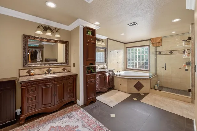 a front view of a house with a garden and palm trees