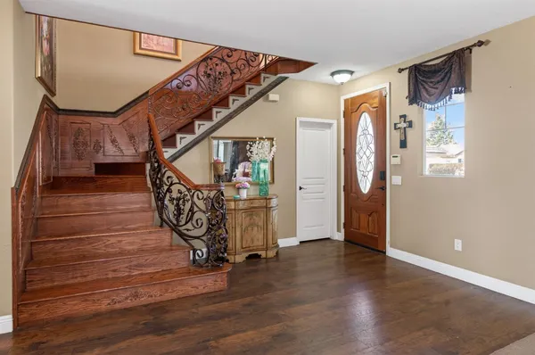 a view of entryway and hall with wooden floor