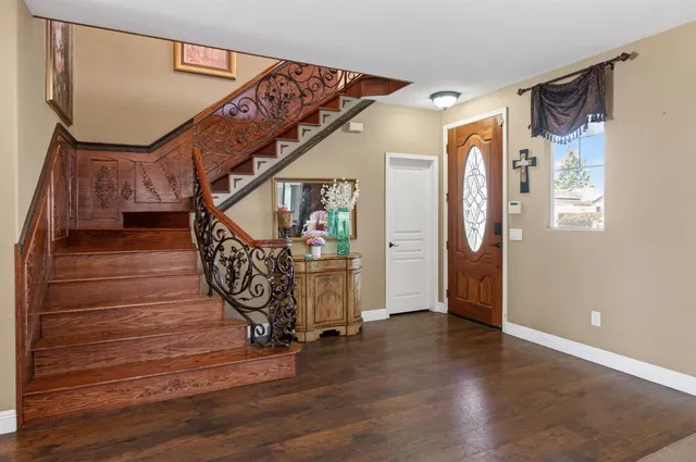 a view of entryway and hall with wooden floor