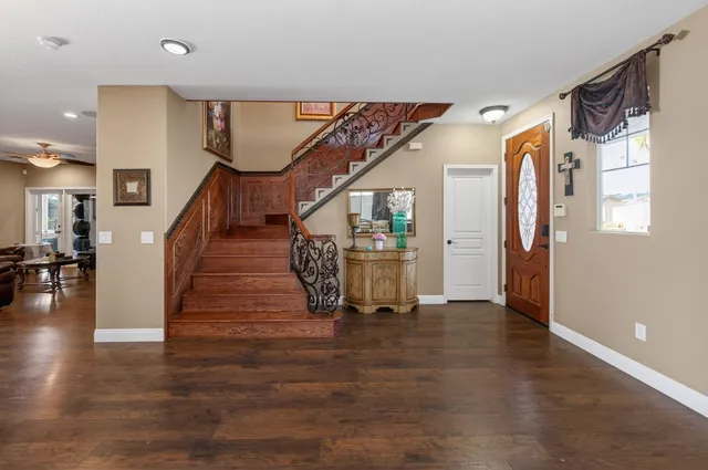 a view of an entryway with wooden floor