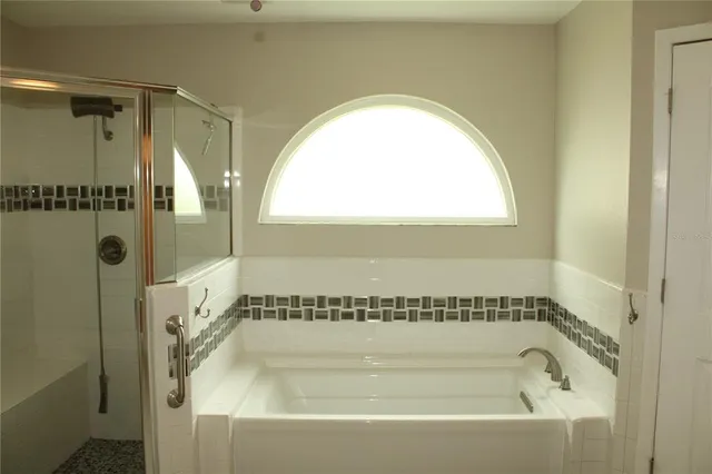 a bathroom with a tub and shower