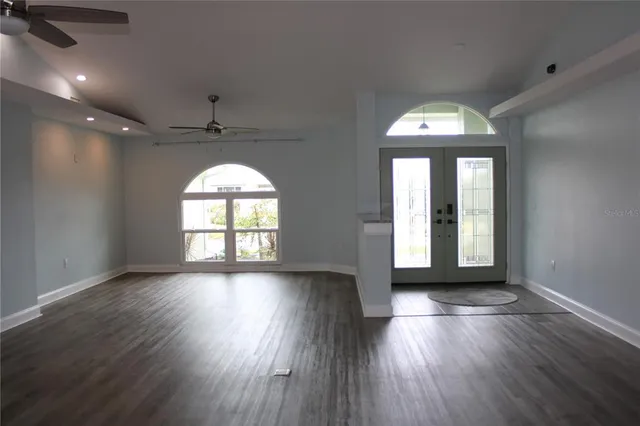 a view of a room with wooden floors and window