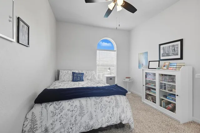 a bedroom with a bed and a view of kitchen